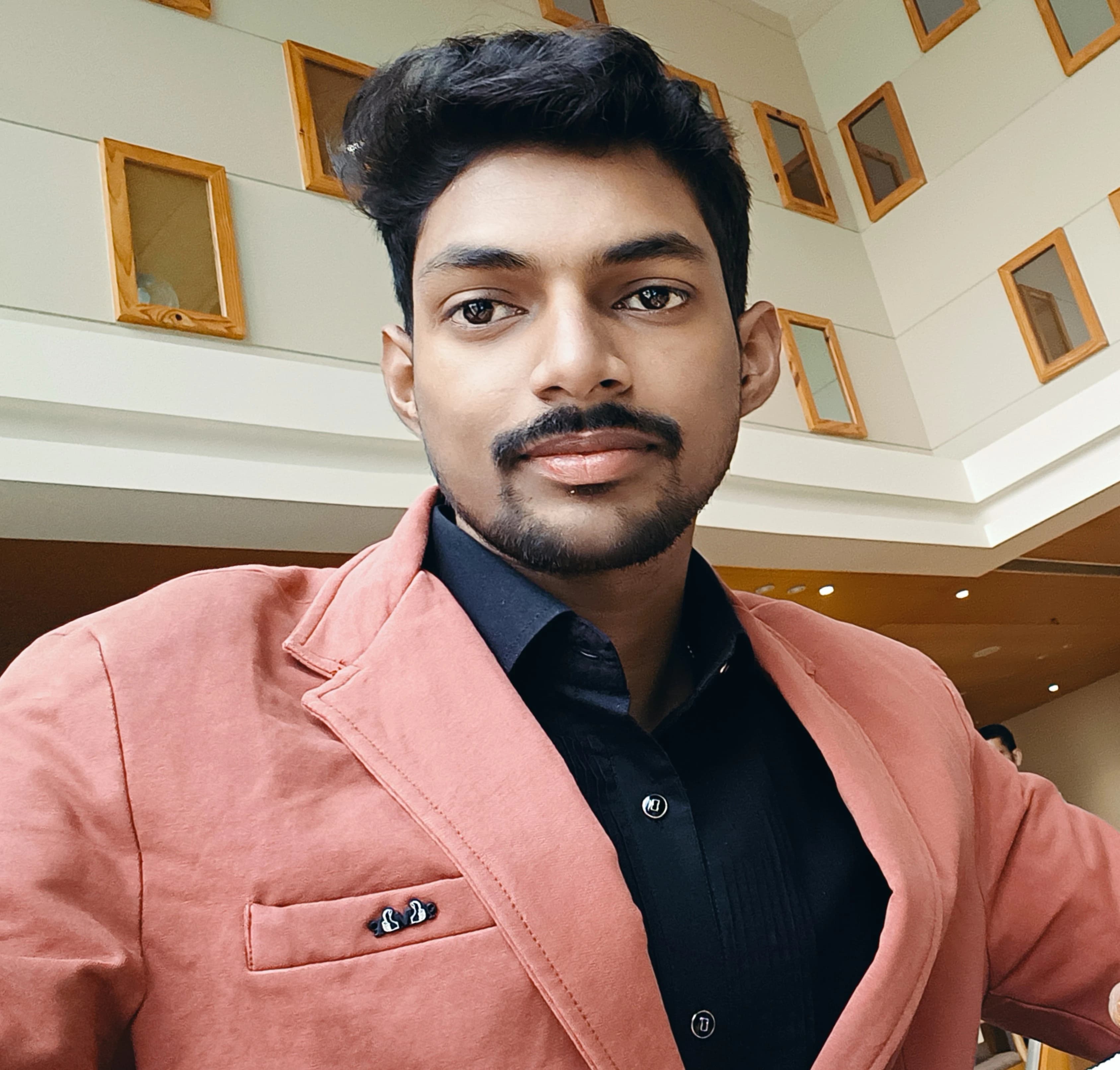 Aditya Kumar in a coral blazer